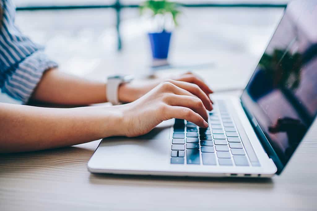 A person typing on a keyboard.