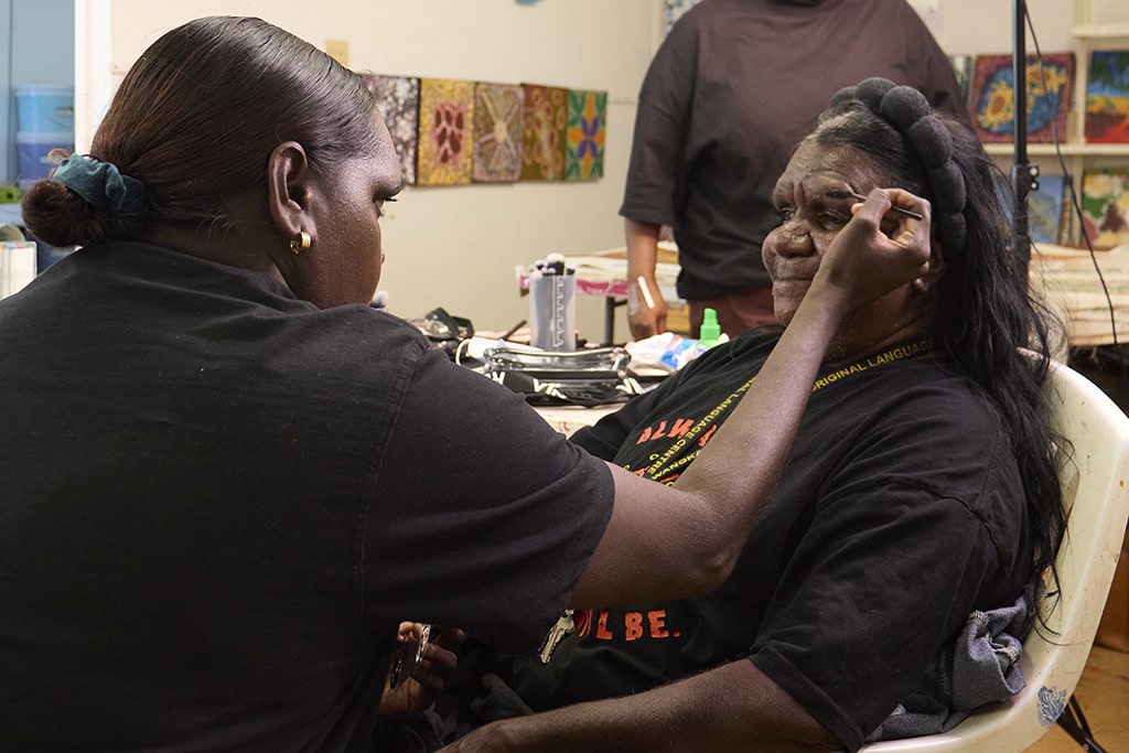 Participant applying makeup during the Bidyadanga fashion and runway project